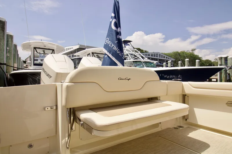 Slide: The Image of 2025 Chris-Craft Calypso 32 boat interior with seating and docked boats in background. - 42