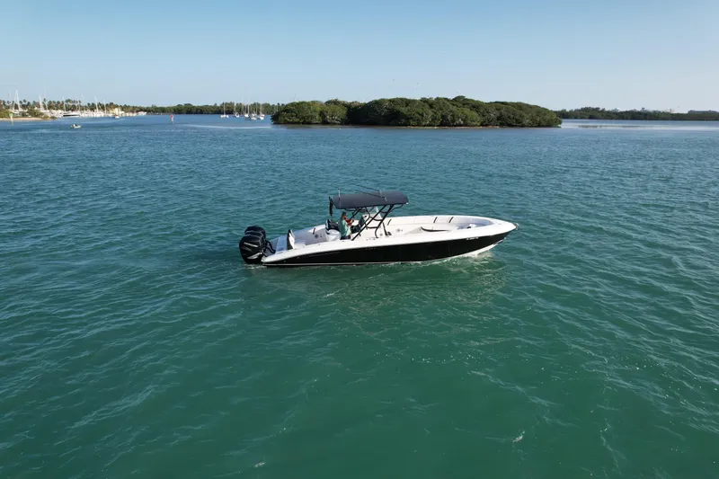 Slide: The Image of 2009 Midnight Express 34' Open boat on calm water near an island. - 1