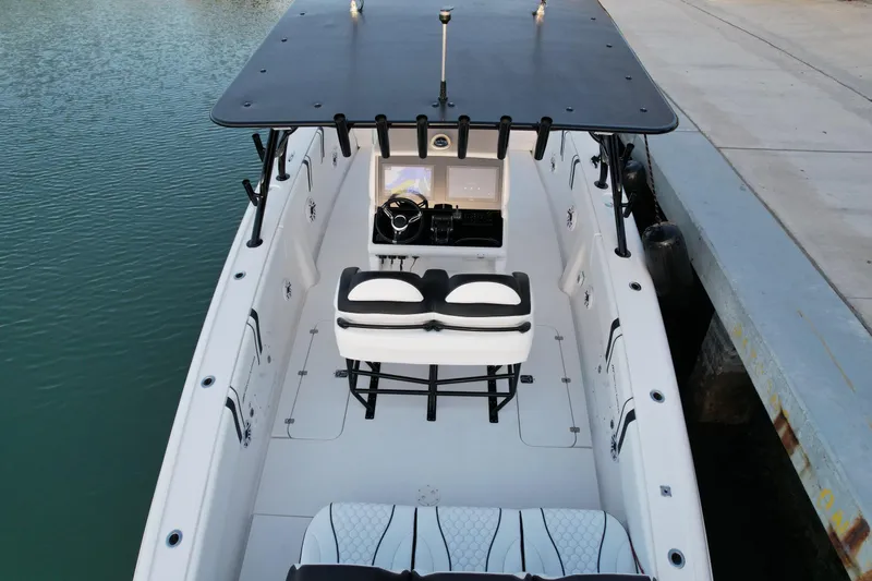 Slide: The Image of 2009 Midnight Express 34' Open boat docked, featuring spacious seating and modern helm. - 10