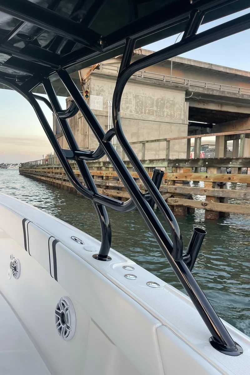 Slide: The Image of 2009 Midnight Express 34' Open boat near a bridge, showcasing sleek design and sturdy construction. - 21