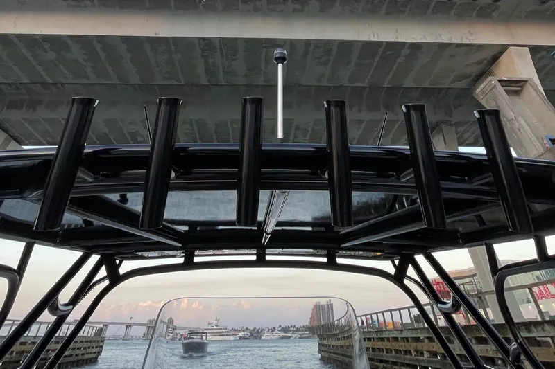 Slide: The Image of 2009 Midnight Express 34' Open boat under a bridge, with a view of the waterway. - 22