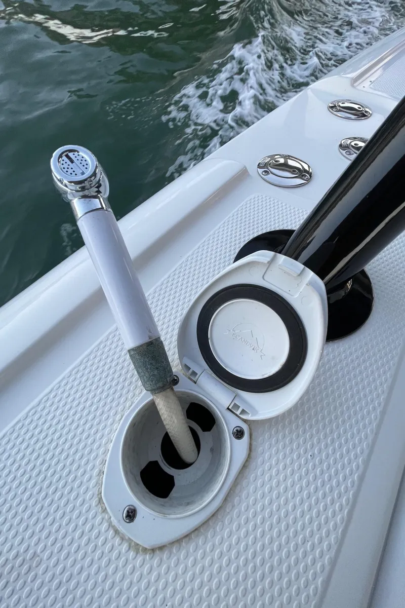 Slide: The Image of 2009 Midnight Express 34' Open boat deck with water hose and fittings. - 23