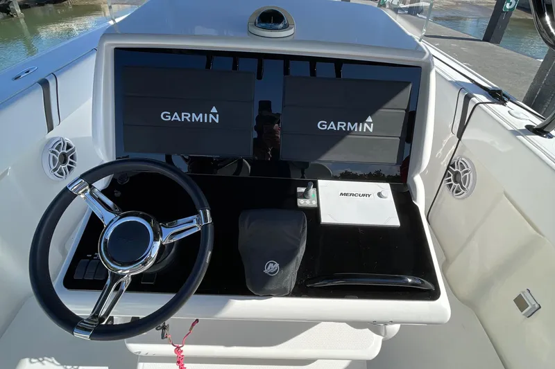 Slide: The Image of 2009 Midnight Express 34' Open boat dashboard with Garmin displays and Mercury controls. - 33