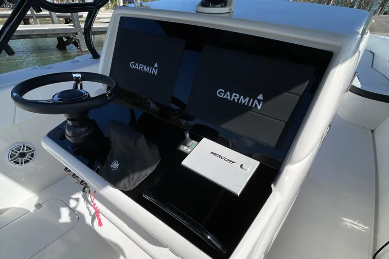 Slide: The Image of 2009 Midnight Express 34' Open boat dashboard with Garmin displays and Mercury controls. - 34