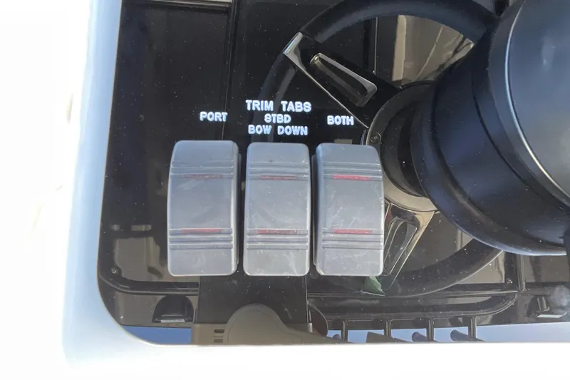 Slide: The Image of 2009 Midnight Express 34' Open trim tab controls on boat dashboard. - 36