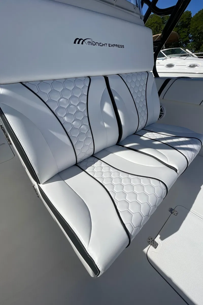 Slide: The Image of 2009 Midnight Express 34' Open boat with white cushioned seating. - 38