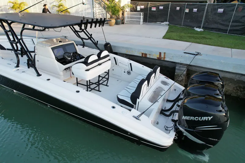 Slide: The Image of 2009 Midnight Express 34' Open boat with triple Mercury engines docked in marina. - 8