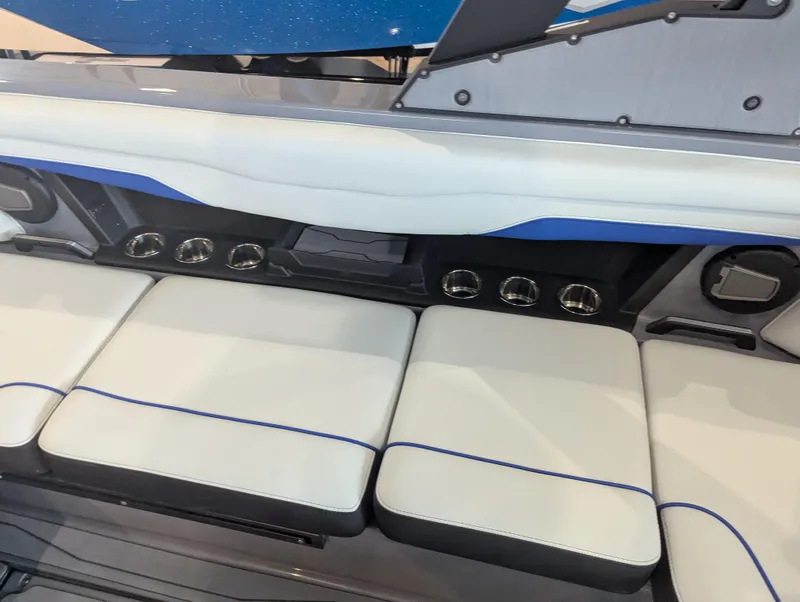 Slide: The Image of 2025 Axis T220 boat interior with white seating and blue accents. - 10