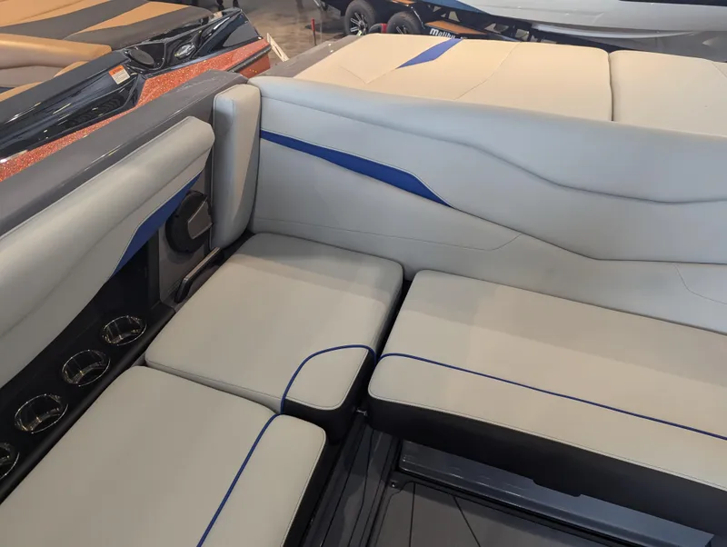 Slide: The Image of 2025 Axis T220 boat interior with sleek gray and blue seating design. - 12