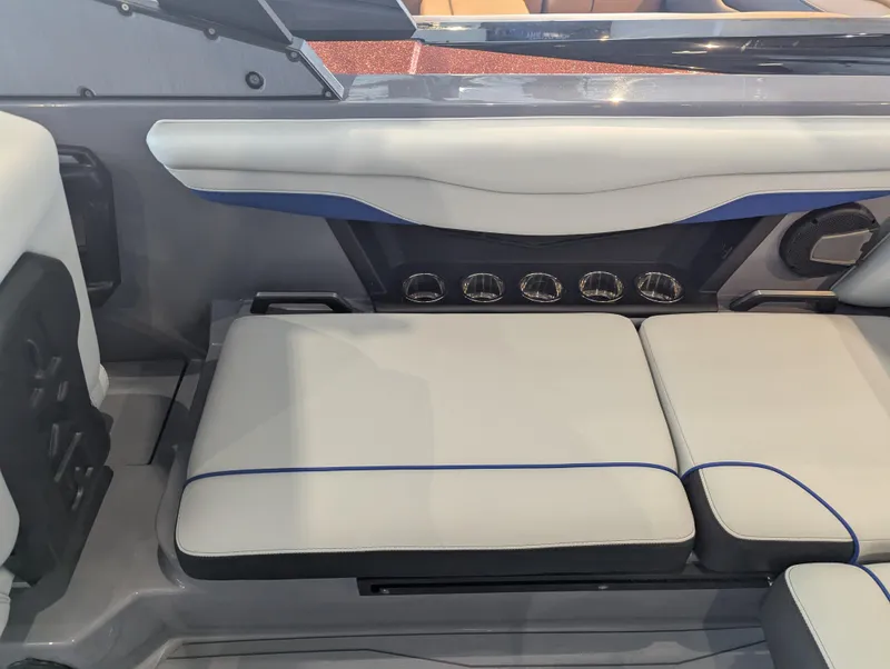 Slide: The Image of 2025 Axis T220 boat interior with cushioned seating and modern design elements. - 13