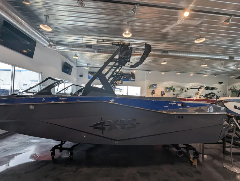 Slide: The Image of 2025 Axis T220 boat displayed in a showroom with modern lighting. - 2