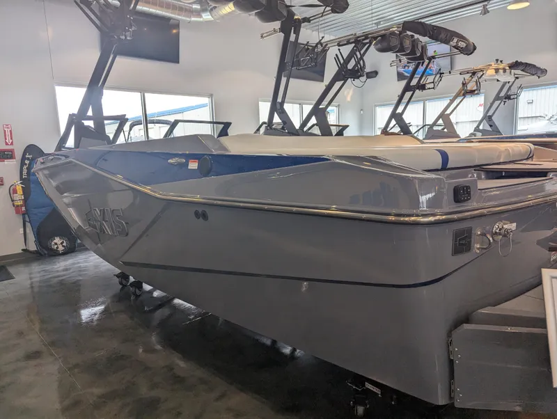 Slide: The Image of 2025 Axis T220 boat in showroom, sleek gray design with modern features. - 4