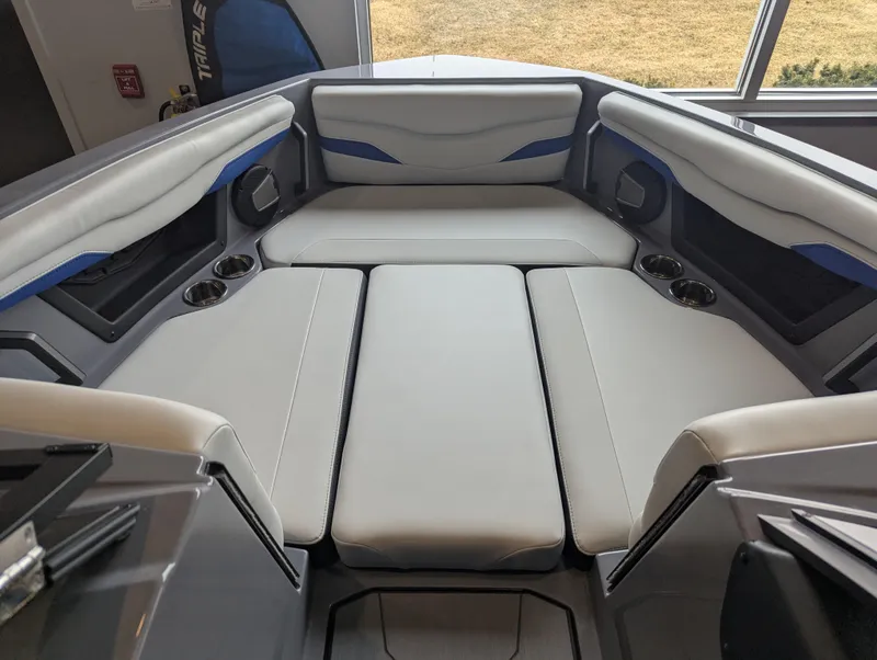 Slide: The Image of 2025 Axis T220 boat interior with cushioned seating and cup holders. - 5