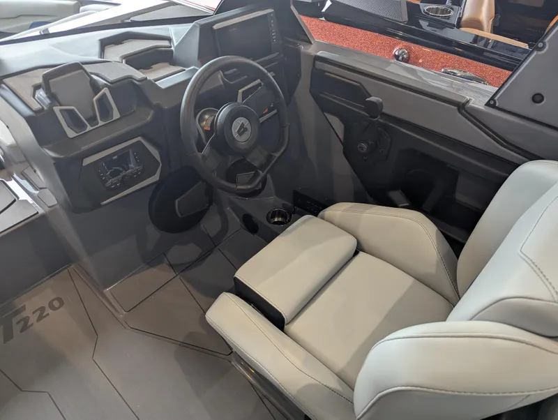 Slide: The Image of 2025 Axis T220 boat interior with modern steering wheel and comfortable seating. - 8