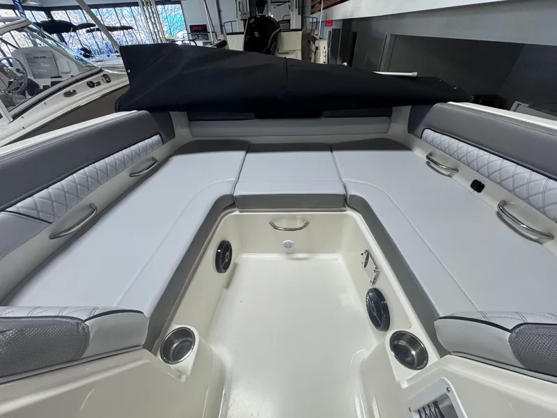 Slide: The Image of 2025 Bayliner D22 boat interior with cushioned seating and cup holders. - 3