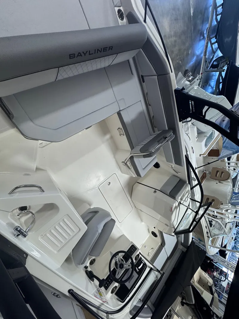 Slide: The Image of 2025 Bayliner D22 boat interior with steering wheel and seating area. - 8