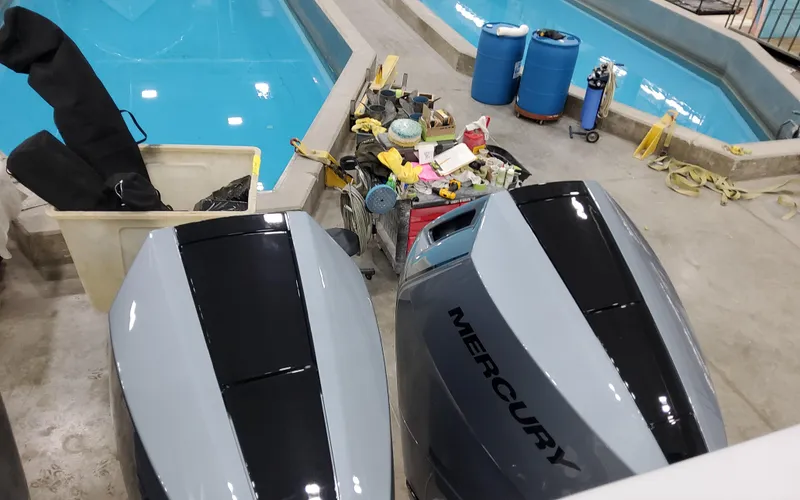 Slide: The Image of 2025 Formula 400 Super Sport Crossover with Mercury engines near a pool and maintenance equipment. - 13