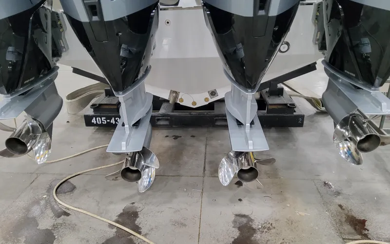 Slide: The Image of 2025 Formula 400 Super Sport Crossover boat engines and propellers in a workshop. - 16