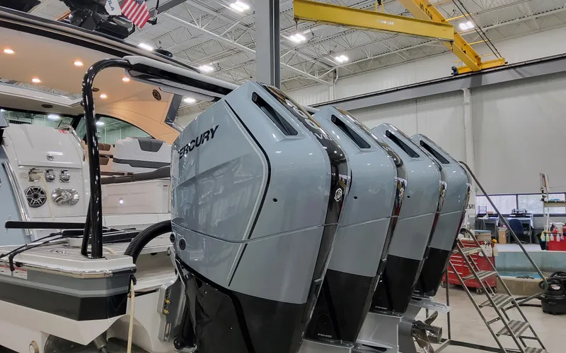 Slide: The Image of 2025 Formula 400 Super Sport Crossover with four Mercury outboard engines in a workshop. - 18