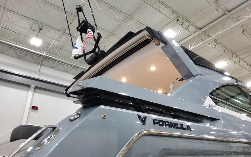 Slide: The Image of 2025 Formula 400 Super Sport Crossover yacht in showroom, showcasing sleek design and modern features. - 2