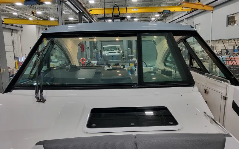 Slide: The Image of 2025 Formula 400 Super Sport Crossover boat in a workshop setting. - 24