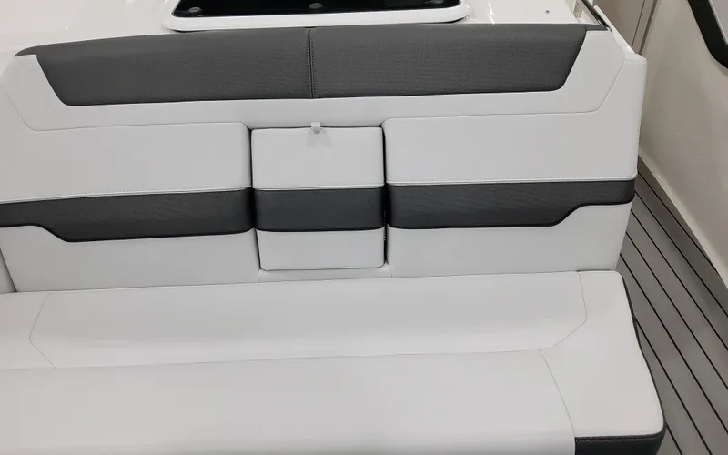 Slide: The Image of 2025 Formula 400 Super Sport Crossover boat interior seating, featuring sleek white and gray upholstery. - 26