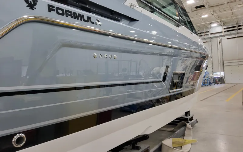 Slide: The Image of 2025 Formula 400 Super Sport Crossover boat in a showroom, side view. - 3
