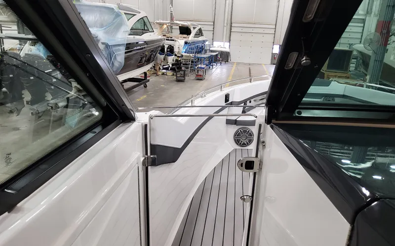 Slide: The Image of 2025 Formula 400 Super Sport Crossover interior view in a boatyard setting. - 36