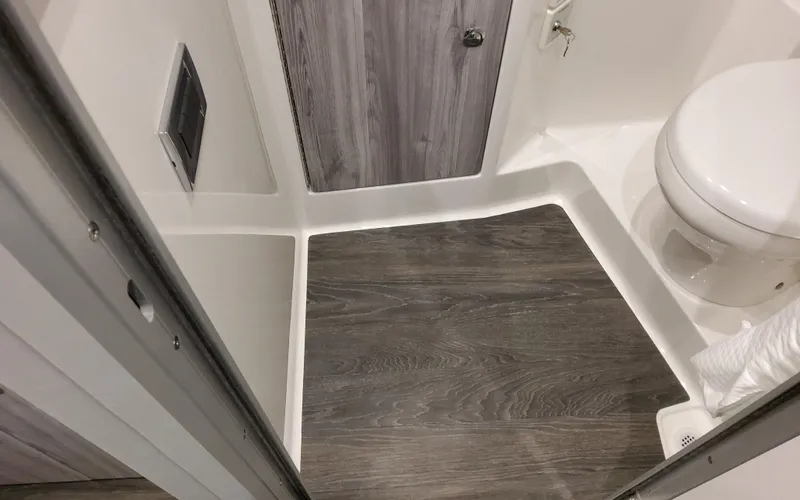 Slide: The Image of 2025 Formula 400 Super Sport Crossover bathroom with modern wood flooring and compact design. - 41