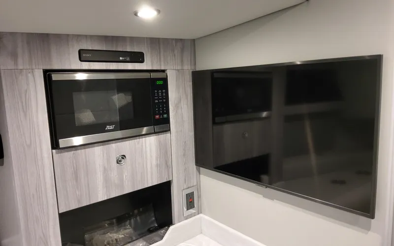 Slide: The Image of Modern kitchen area in 2025 Formula 400 Super Sport Crossover with microwave and flat-screen TV. - 47