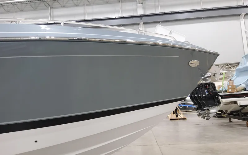 Slide: The Image of 2025 Formula 400 Super Sport Crossover boat in a showroom, side view. - 7