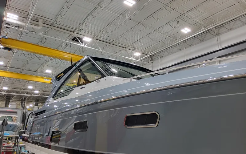 Slide: The Image of 2025 Formula 400 Super Sport Crossover boat in a well-lit indoor facility. - 8