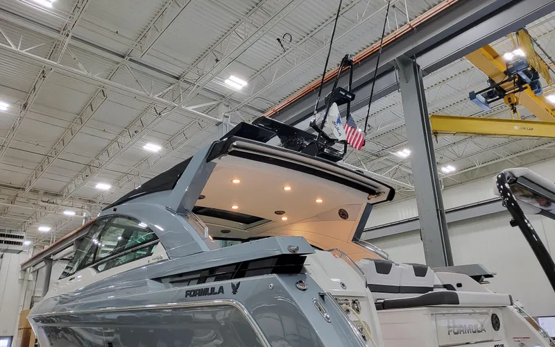 Slide: The Image of 2025 Formula 400 Super Sport Crossover yacht in a modern indoor facility. - 9