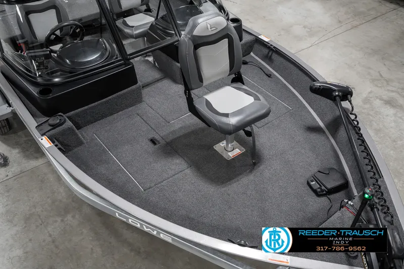 Slide: The Image of 2023 Lowe FM 1775 fishing boat interior with seating and steering console. - 11