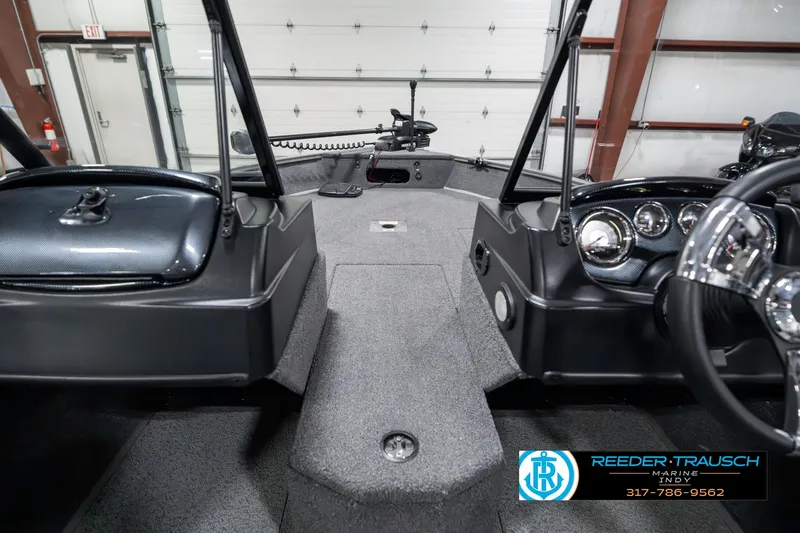Slide: The Image of Interior view of 2023 Lowe FM 1775 boat, featuring modern dashboard and controls. - 15