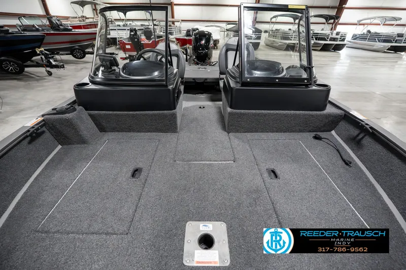 Slide: The Image of 2023 Lowe FM 1775 boat interior with dual consoles in showroom. - 17