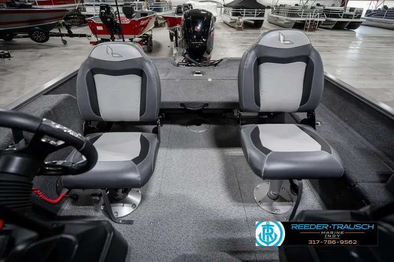 Slide: The Image of 2023 Lowe FM 1775 boat interior with two gray seats in a showroom. - 18