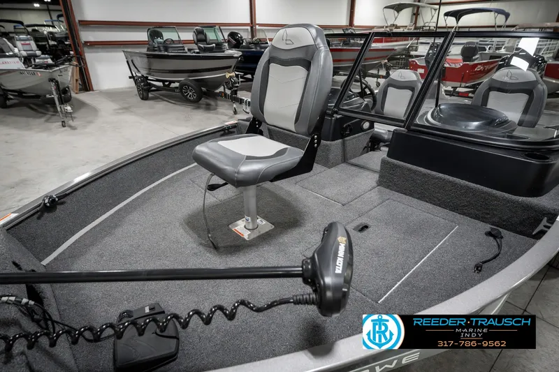Slide: The Image of 2023 Lowe FM 1775 boat interior with seating and trolling motor in showroom. - 20