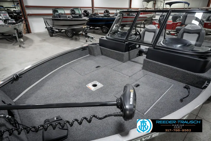 Slide: The Image of 2023 Lowe FM 1775 boat interior in showroom, featuring spacious seating and modern design. - 21