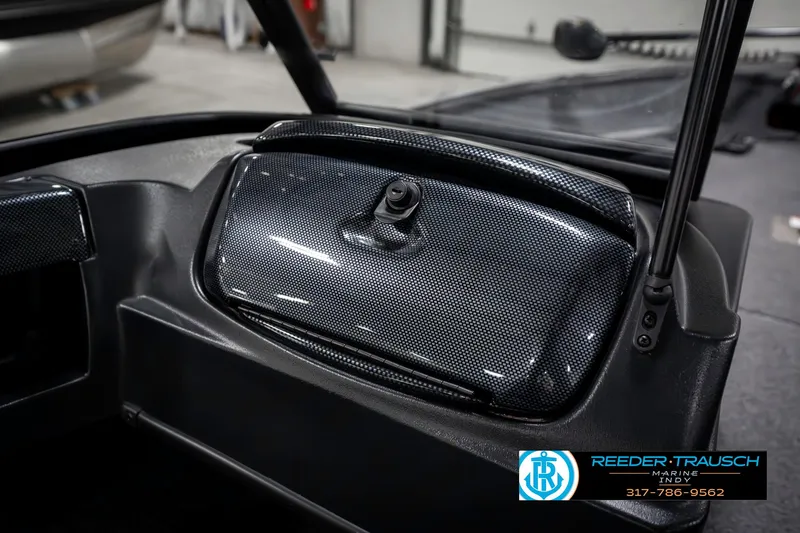 Slide: The Image of 2023 Lowe FM 1775 dashboard with carbon fiber finish, featuring a storage compartment. - 25