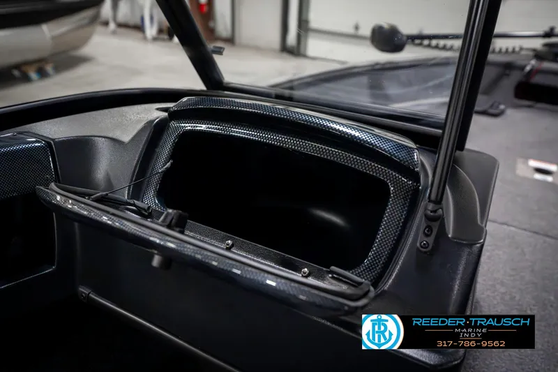 Slide: The Image of 2023 Lowe FM 1775 boat interior with open storage compartment, Reeder-Trausch logo visible. - 26