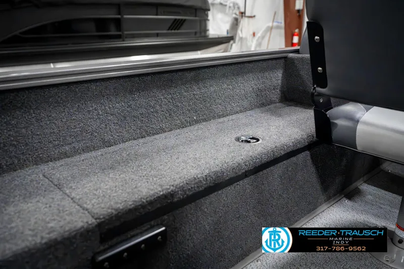 Slide: The Image of 2023 Lowe FM 1775 boat interior with carpeted flooring and seating. - 27