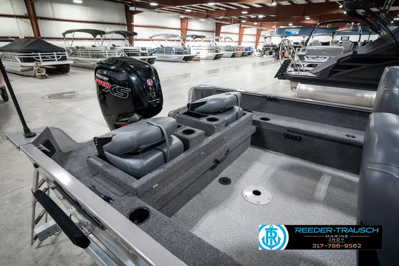 Slide: The Image of 2023 Lowe FM 1775 boat interior with seating and motor in showroom. - 31