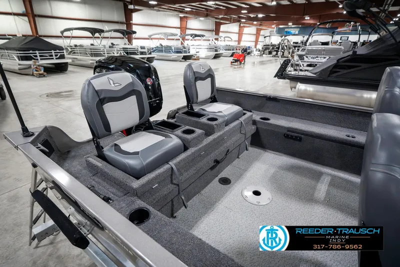 Slide: The Image of 2023 Lowe FM 1775 boat interior with dual seats in a showroom. - 32