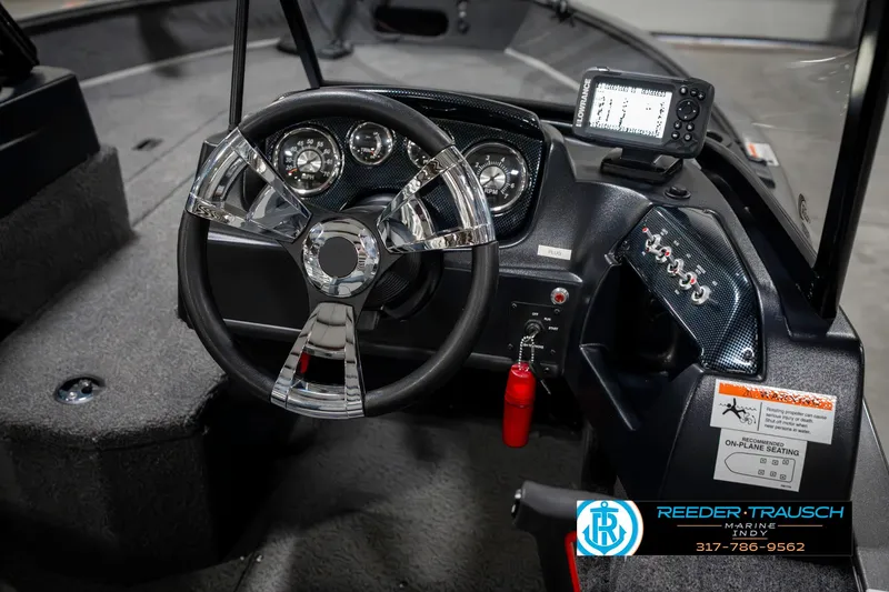 Slide: The Image of 2023 Lowe FM 1775 boat dashboard with steering wheel and navigation system. - 34