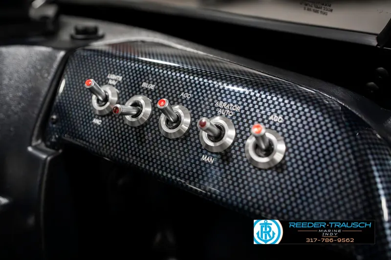 Slide: The Image of Switch panel in a 2023 Lowe FM 1775 boat with carbon fiber finish. - 38
