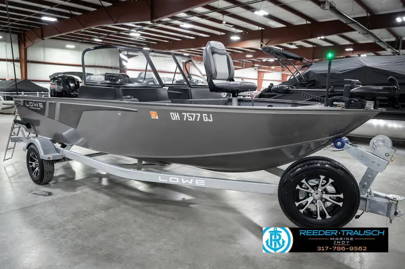 Slide: The Image of 2023 Lowe FM 1775 boat on trailer in indoor showroom. - 4