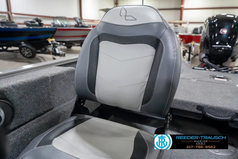 Slide: The Image of 2023 Lowe FM 1775 boat seat in showroom, featuring gray and white upholstery. - 41