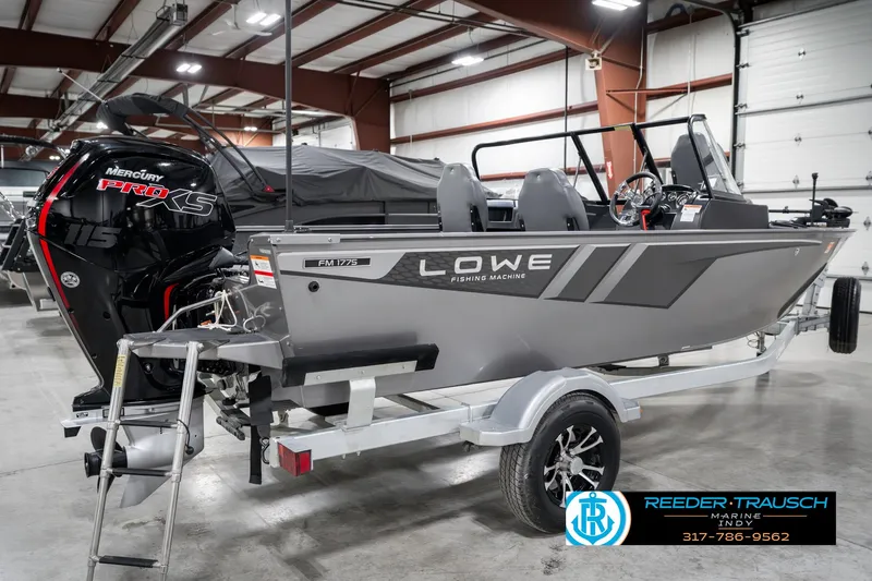 Slide: The Image of 2023 Lowe FM 1775 fishing boat on trailer in indoor showroom. - 6