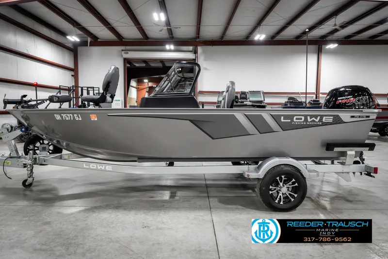 Slide: The Image of 2023 Lowe FM 1775 boat in showroom, side view, on trailer. - 9